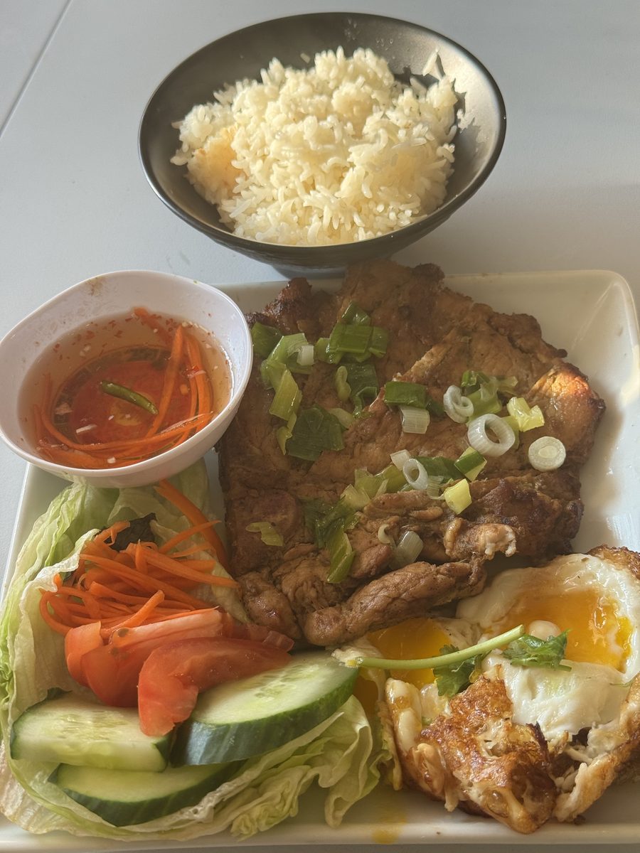 Marinated pork chop with fried eggs, rice, cucumber and pickled carrots — a Lotus & Lime signature.