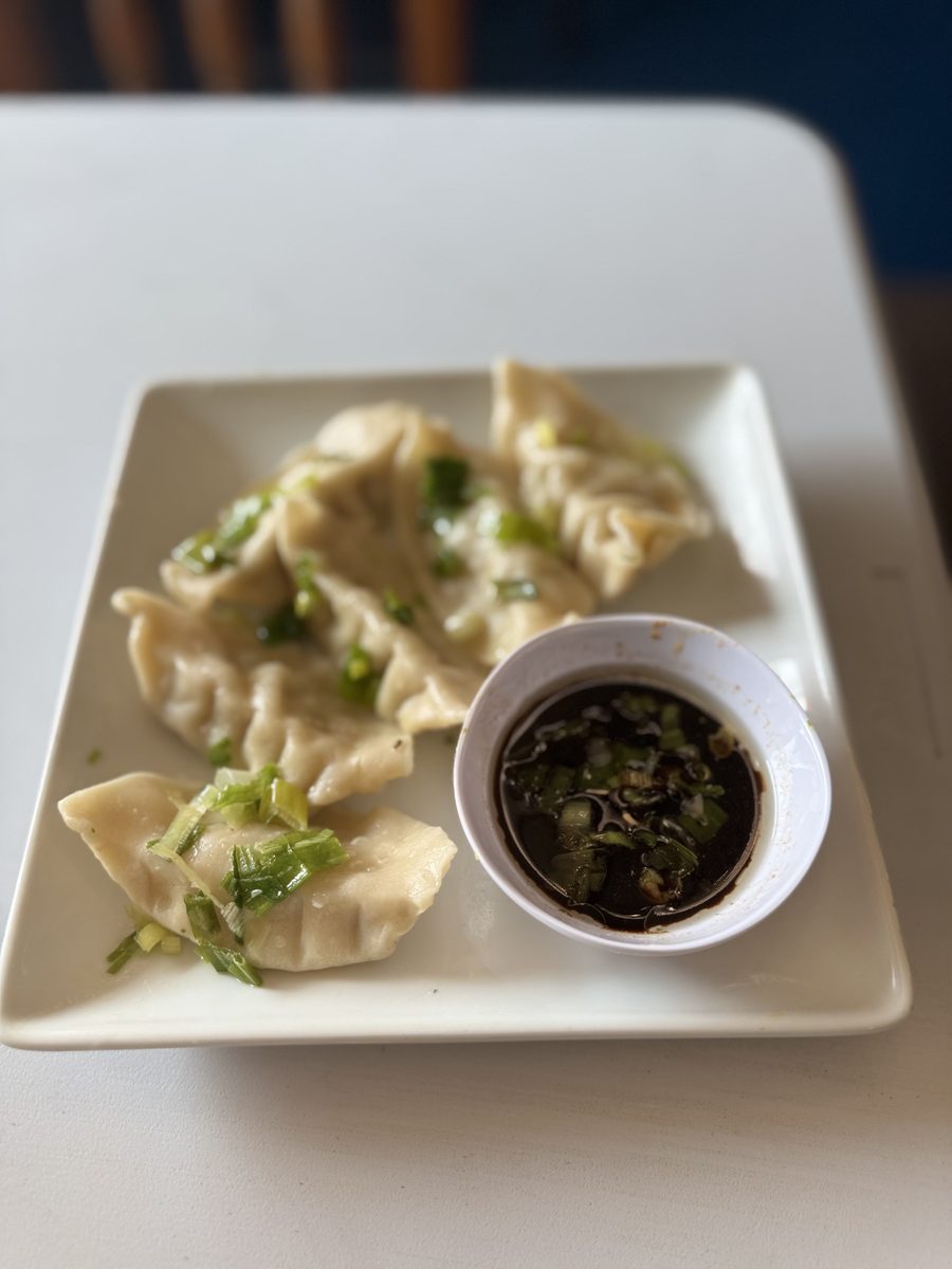 Six pan-fried pork potstickers with dipping sauce